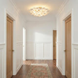 Layla Semi-Flush 22", White Glass scalloped Flush Mount in a Transitional Hallway with white wainscoting and a patterned rug.