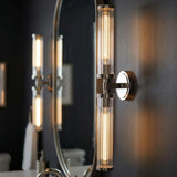 Dexter 2 Light Wall Sconce 29", Polished Nickel linear Wall Sconce in a Contemporary Bathroom with an oval mirror.