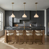 Claire Small Pendant 10", Brass and Strie Glass scalloped Pendant in a Modern Farmhouse Kitchen with charcoal cabinets and cream stools.