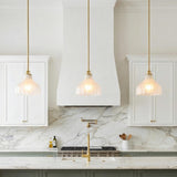 Claire Small Pendant 10", Brass and Strie Glass scalloped Pendant in a Transitional Kitchen with white marble island and backsplash.