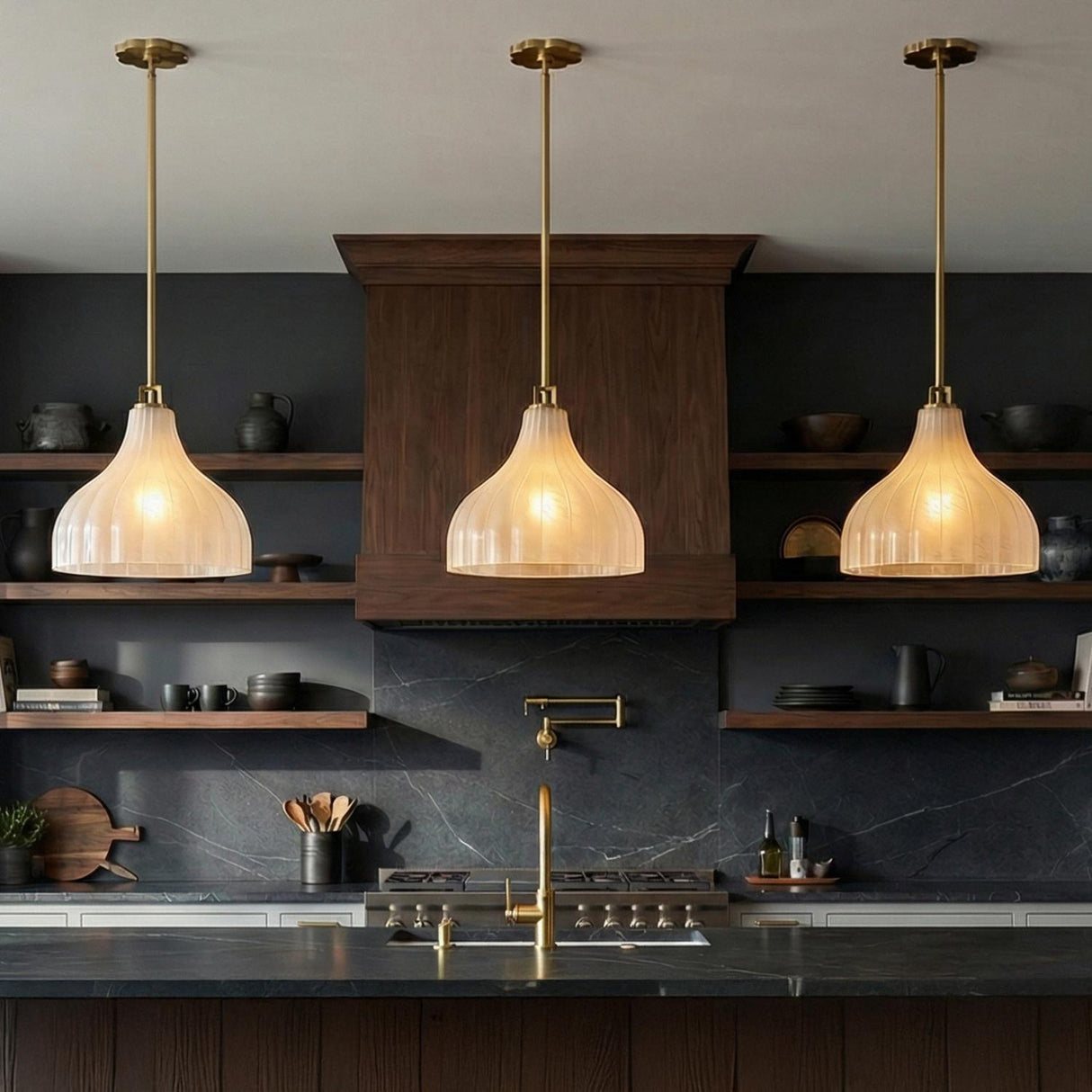 Claire Medium Pendant 15", Brass and Strie Glass Brass scalloped Pendant in a Modern Kitchen with dark marble and walnut shelves.