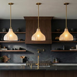Claire Medium Pendant 15", Brass and Strie Glass Brass scalloped Pendant in a Modern Kitchen with dark marble and walnut shelves.