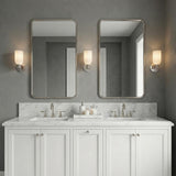 Elise Wall Sconce 11", Polished Nickel and Ribbed Strie Glass scalloped Wall Sconce in a Transitional Bathroom with a double vanity.