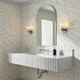 Eliza Wall Sconce 9", Polished Nickel and Clear Ribbed Glass Nickel scalloped Sconce in a Transitional Bathroom with a marble vanity.