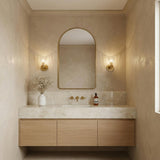 Eliza Wall Sconce 9", Brass and Clear Ribbed Glass scalloped Wall Sconce in a Contemporary Bathroom with an arched mirror and marble vanity.