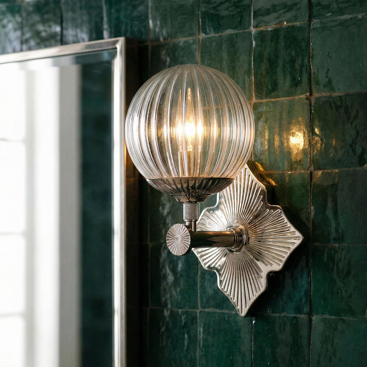 Victoria Wall Sconce, Polished Nickel and Clear Ribbed Glass globe Wall Sconce in a Contemporary Bathroom with emerald green tile.