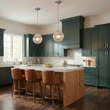 Victoria Polished Nickel ribbed glass globe pendant in a Modern Farmhouse Kitchen with green cabinets and leather barstools.