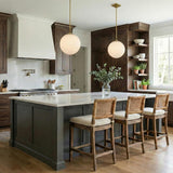 Victoria Pendant 14", Aged Brass and Opal Ribbed Glass globe pendant in a Transitional Kitchen with a marble island and cane back stools.