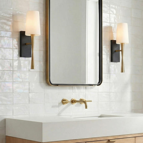 Kellan Wall Sconce 18", Aged Brass and Black geometric Wall Sconce in a Modern Bathroom with iridescent white tile.