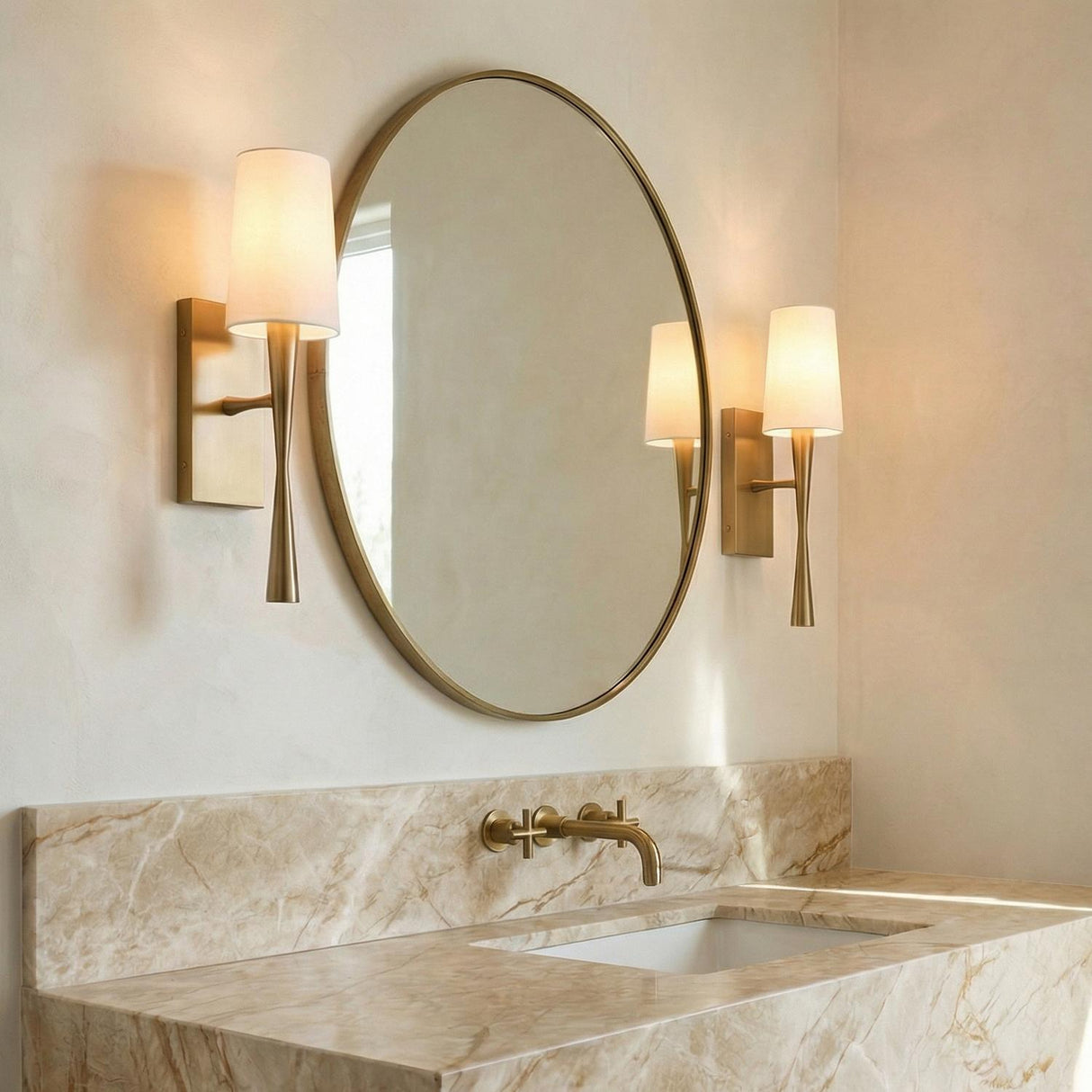 Kellan Wall Sconce 18", Aged Brass geometric wall sconce in a Contemporary Bathroom with a round mirror and marble vanity.