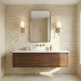 Kellan Wall Sconce, Polished Nickel linear Wall Sconce in a Contemporary Bathroom with a floating wood vanity and stone wall.