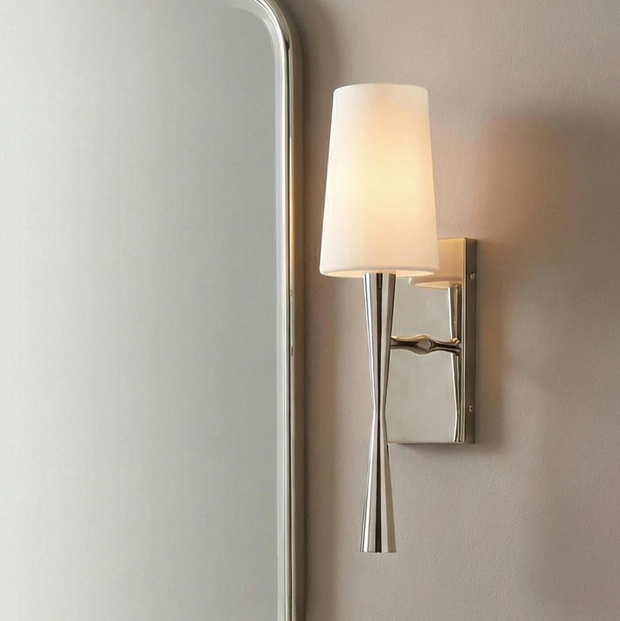 Kellan Wall Sconce 18", Polished Nickel linear Wall Sconce in a Contemporary Bathroom with a silver framed mirror.