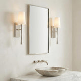 Kellan Wall Sconce 18", Polished Nickel linear Wall Sconce in a Transitional Bathroom with a marble countertop and stone vessel sink.