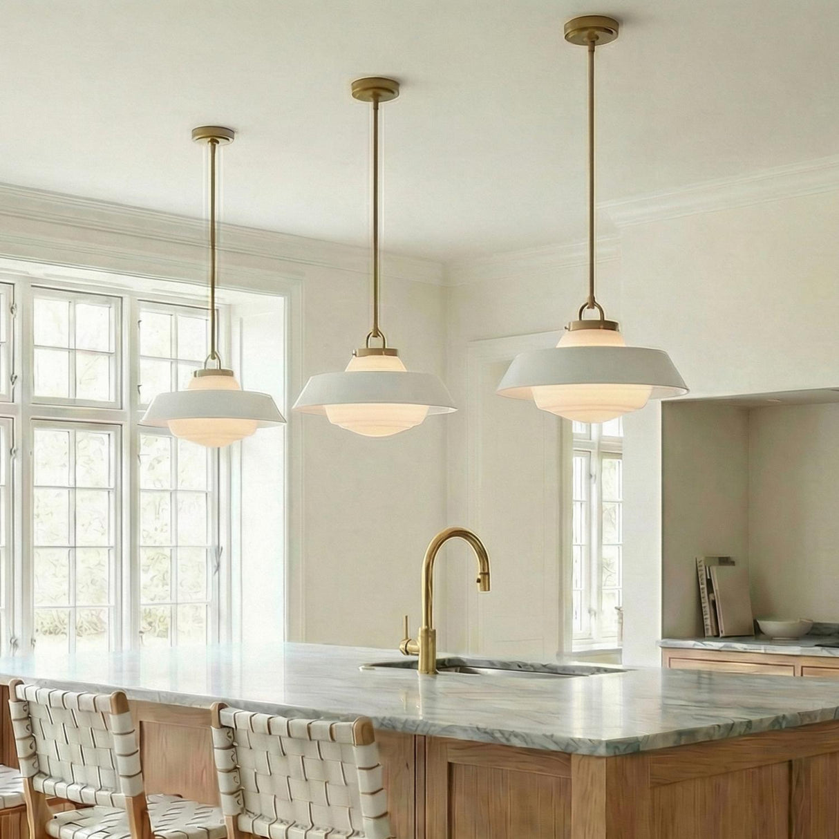 Blaine Medium Pendant 16", Brass and White geometric globe Pendant in a Transitional Kitchen with a marble island and brass faucet.