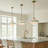 Blaine Medium Pendant 16", Brass and White geometric globe Pendant in a Transitional Kitchen with a marble island and brass faucet.