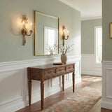 Bow Ribbon Antique Brass ribbon design Wall Sconce in a Traditional Entryway with a wooden console table and gold mirror.