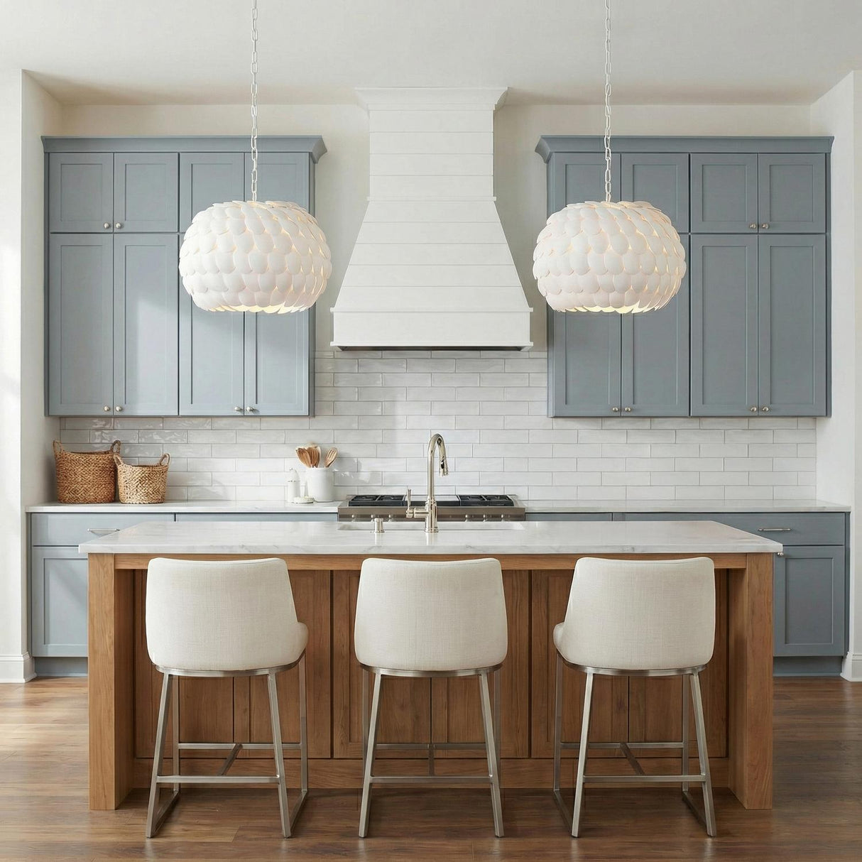 Odette Pendant 20", Matte White Coco Shells scalloped pendant in a Coastal Kitchen with a white marble island and blue cabinets.