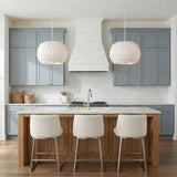 Odette Pendant 20", Matte White Coco Shells scalloped pendant in a Coastal Kitchen with a white marble island and blue cabinets.