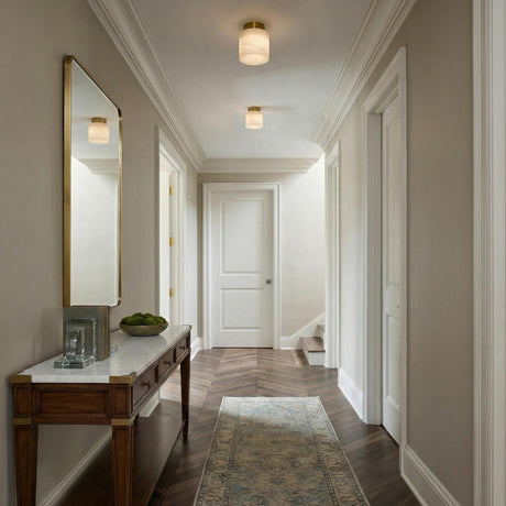 Clark Extra Small Flush Mount 6", Aged Brass and Alabaster geometric flush mount in a Transitional Hallway with a marble console table.