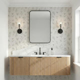 Silas Matte Black faceted crystal Wall Sconce in a Transitional Bathroom with a fluted wood vanity and marble countertop.