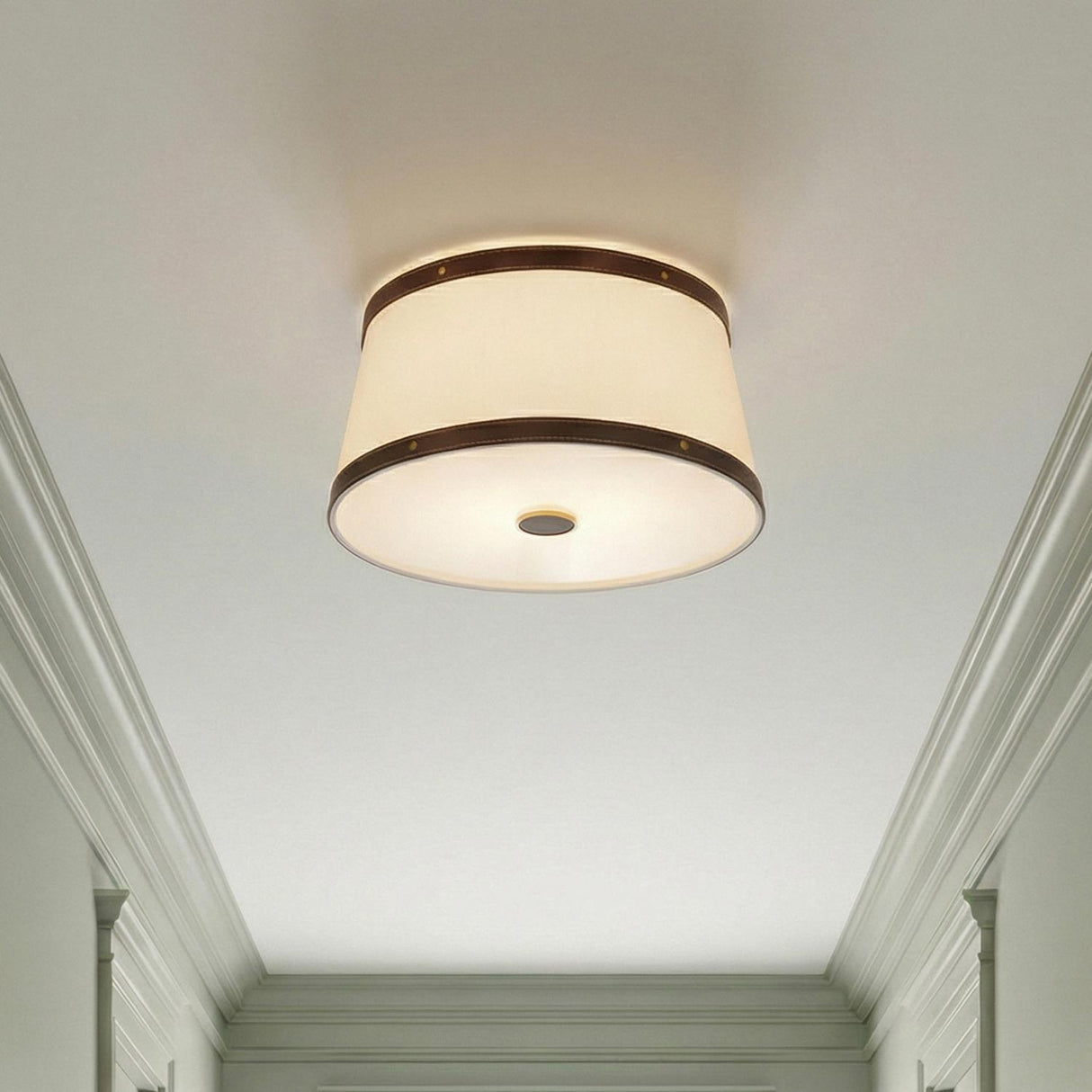 Spencer Flush Mount 17", Brass with Brown Leather Accents geometric Flush Mount in a Transitional Hallway with classic white crown molding.