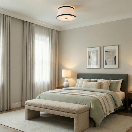 White and Matte Black geometric flush mount in a Transitional Bedroom with a green upholstered bed and textured bench.