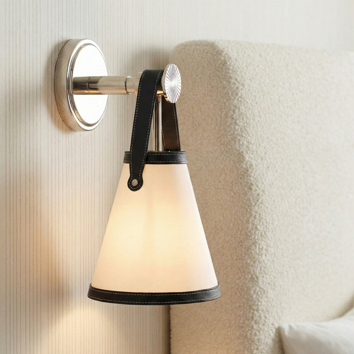 Spencer Wall Sconce, Polished Nickel with Black Leather Accents geometric Wall Sconce in a Transitional Bedroom with a boucle headboard.