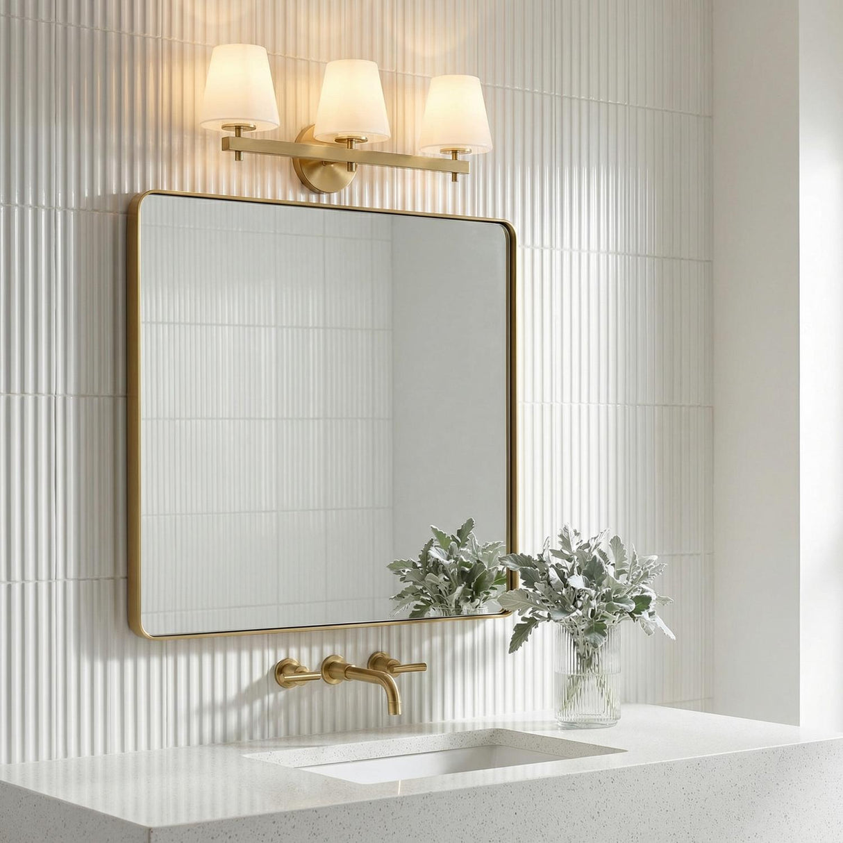 Atticus 3 Light Vanity, Brass and Opal Glass linear vanity in a Contemporary Bathroom with fluted white tiles and gold mirror.