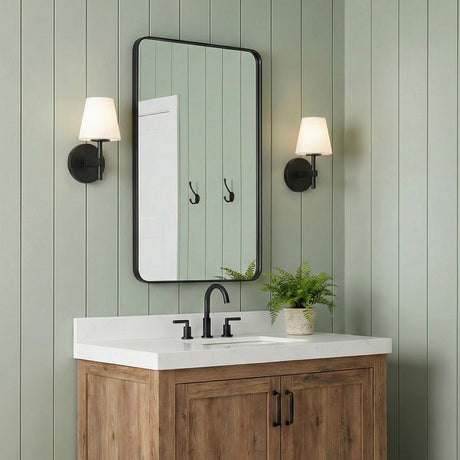 Atticus Wall Sconce 11", Black and White geometric Wall Sconce in a Modern Farmhouse Bathroom with a wood vanity and green paneling.