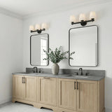 Atticus 3 Light Vanity, Black and Opal Glass linear Vanity in a Transitional Bathroom with a double vanity and eucalyptus.