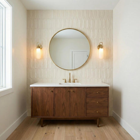 Finnian LED Wall Sconce 13", Brass geometric Wall Sconce in a Mid-Century Bathroom with a walnut vanity and round mirror.