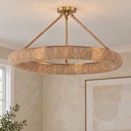 A coastal living room features the Seabrook LED Semi-Flush in Lake Grass and Soft Brass mounted on the ceiling beside textured walls and framed art.