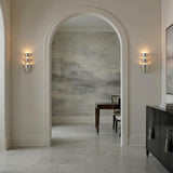 Vedra Wall Sconce 18", Hammered Silver Leaf scalloped texture Wall Sconce in a Transitional Entryway with an arched doorway and gray mural.