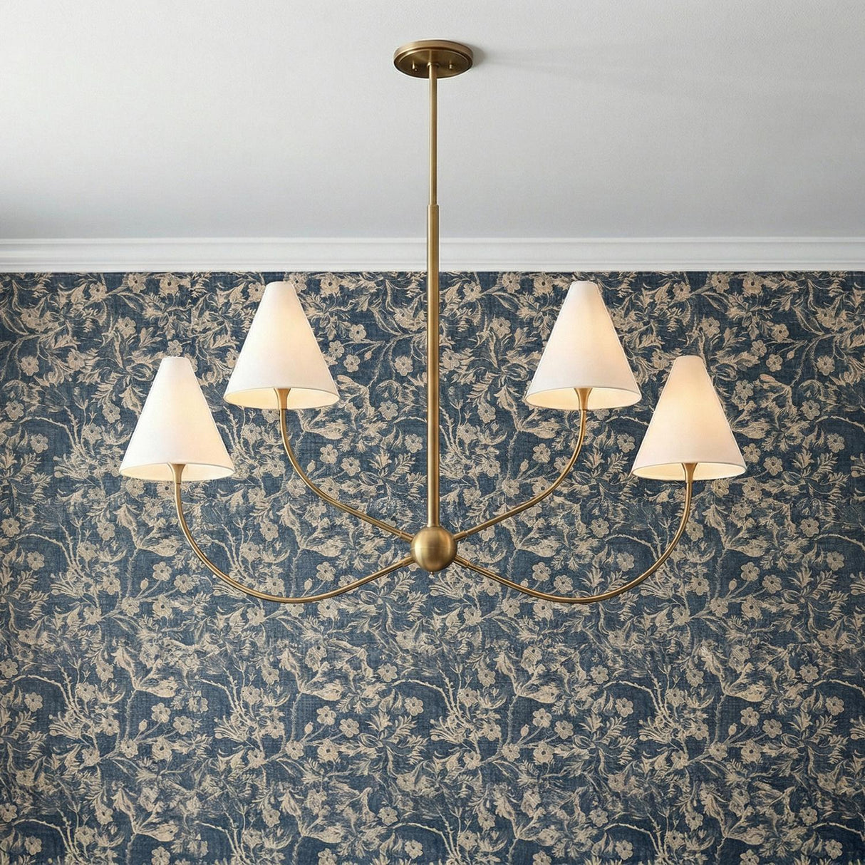 Yara 4 Light Chandelier, Patina Brass scalloped Chandelier in a Traditional Dining Room with blue floral wallpaper.