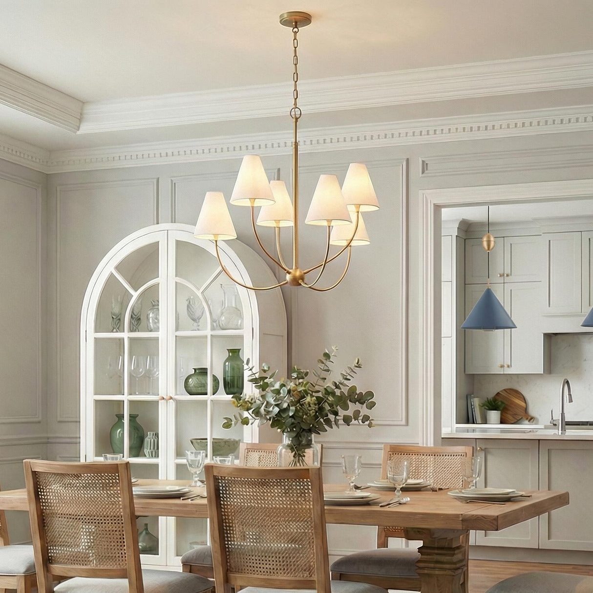Yara 6 Light Chandelier 40", Patina Brass geometric Chandelier in a Transitional Dining Room with cane back chairs and an arched cabinet.
