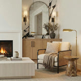 Pratt Single Wall Sconce 21", Old Bronze and Aged Brass linear Wall Sconce in a Contemporary Living Room with an arched mirror.