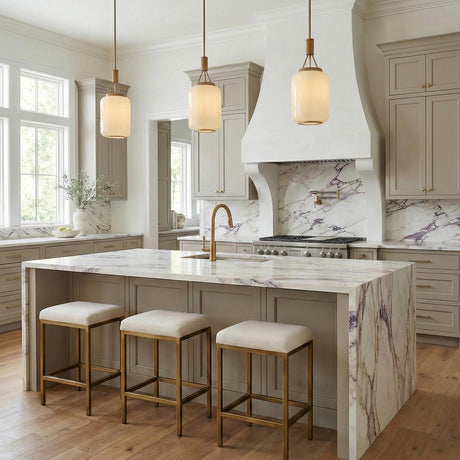 Yuma Pendant 10", Patina Brass and Rattan with Cream Milk Glass cylinder pendant in a Transitional Kitchen with a white marble island.