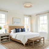 Callen Medium LED Flush Mount 18", Natural Rope woven flush mount in a Coastal Bedroom with a woven cane headboard and blue pillows.