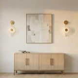 Quella LED Wall Sconce 18", Aged Brass and Piastre Glass Aged Brass geometric Wall Sconce in a Contemporary Living Room with a wood sideboard.