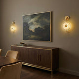 Quella LED Wall Sconce 18", Aged Brass and Piastre Glass geometric wall sconce in a Contemporary Dining Room with a walnut sideboard.