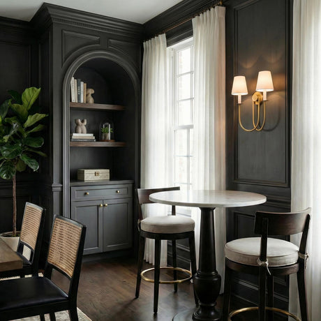 Whitney Double Wall Sconce, Aged Brass and White Linen geometric wall sconce in a Transitional Dining Room with a marble bistro table.