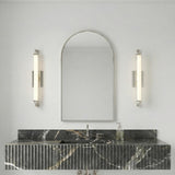 Empire LED Wall Sconce 28", Polished Nickel linear Wall Sconce in a Modern Bathroom with a black fluted marble vanity.