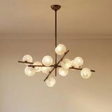 Felix 12 Light Chandelier 42", Bronze Leaf and Seeded Cloud Glass globe chandelier in a Contemporary Dining Room with neutral walls.