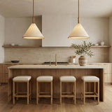 Delora Pendant 24", Patina Brass and Rattan Cream woven pendant in a Contemporary Kitchen with a wooden island and white bar stools.