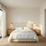 Delora Wall Sconce 9", Patina Brass woven wall sconce in a Transitional Bedroom with a beige upholstered bed and oak nightstands.