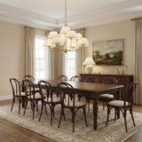 Belmont 9 Light Chandelier 40", Aged Brass tiered chandelier in a Traditional Dining Room with a dark oak table and bentwood chairs.