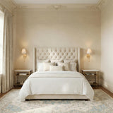 Velora Wall Sconce 12", Gold Leaf linear wall sconce in a Traditional Bedroom with a tufted headboard and marble nightstands.
