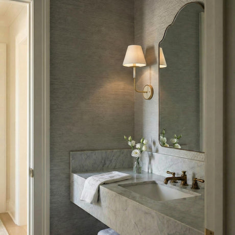 Cicero Wall Sconce 17", Off White and Aged Brass linear Wall Sconce in a Transitional Bathroom with a white marble vanity.