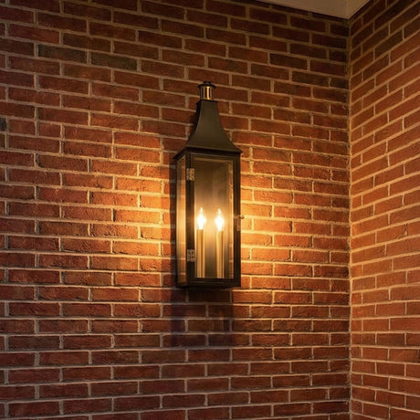 Dante Outdoor Wall Light, Large 24", Black and Brass geometric Outdoor Wall in a Traditional Outdoor space with a red brick wall.