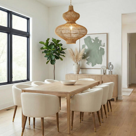 Jaffa Large Pendant 28", Rattan and Patina Brass woven Pendant in a Contemporary Dining Room with a light wood table and white chairs.